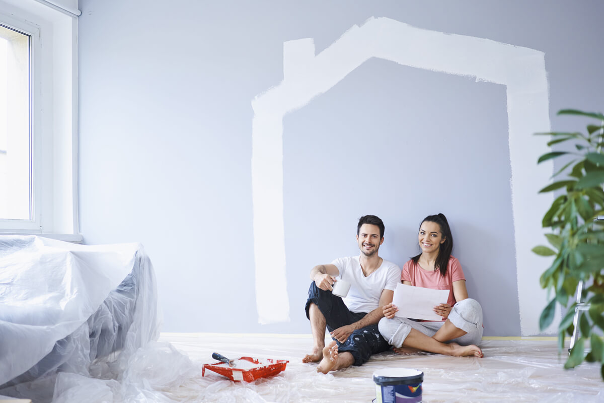 big home renovation project showing kitchen and living room transformation with construction workers and materials