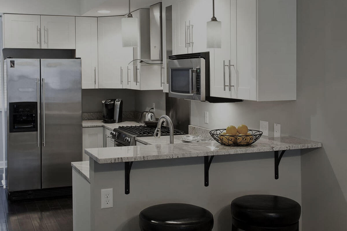 Small kitchen renovation before and after showing compact space transformation with white cabinets and smart storage