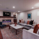 Finished basement in Colorado Springs with modern flooring and lighting showing basement finishing results