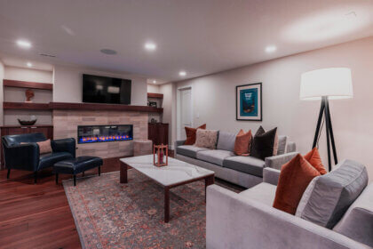 Finished basement in Colorado Springs with modern flooring and lighting showing basement finishing results