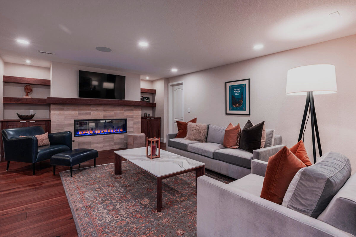 Finished basement in Colorado Springs with modern flooring and lighting showing basement finishing results