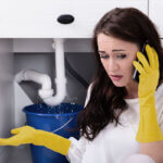 Old house plumbing problems showing corroded pipes, leaky faucets, and pipe belly issues in basement