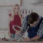 Licensed gas plumber Gold Coast installing gas appliance with safety equipment and tools