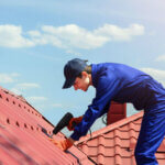 Licensed roofing contractor inspecting residential roof with safety equipment and tools