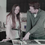 Professional kitchen renovation contractor reviewing blueprints and discussing project plans with homeowner