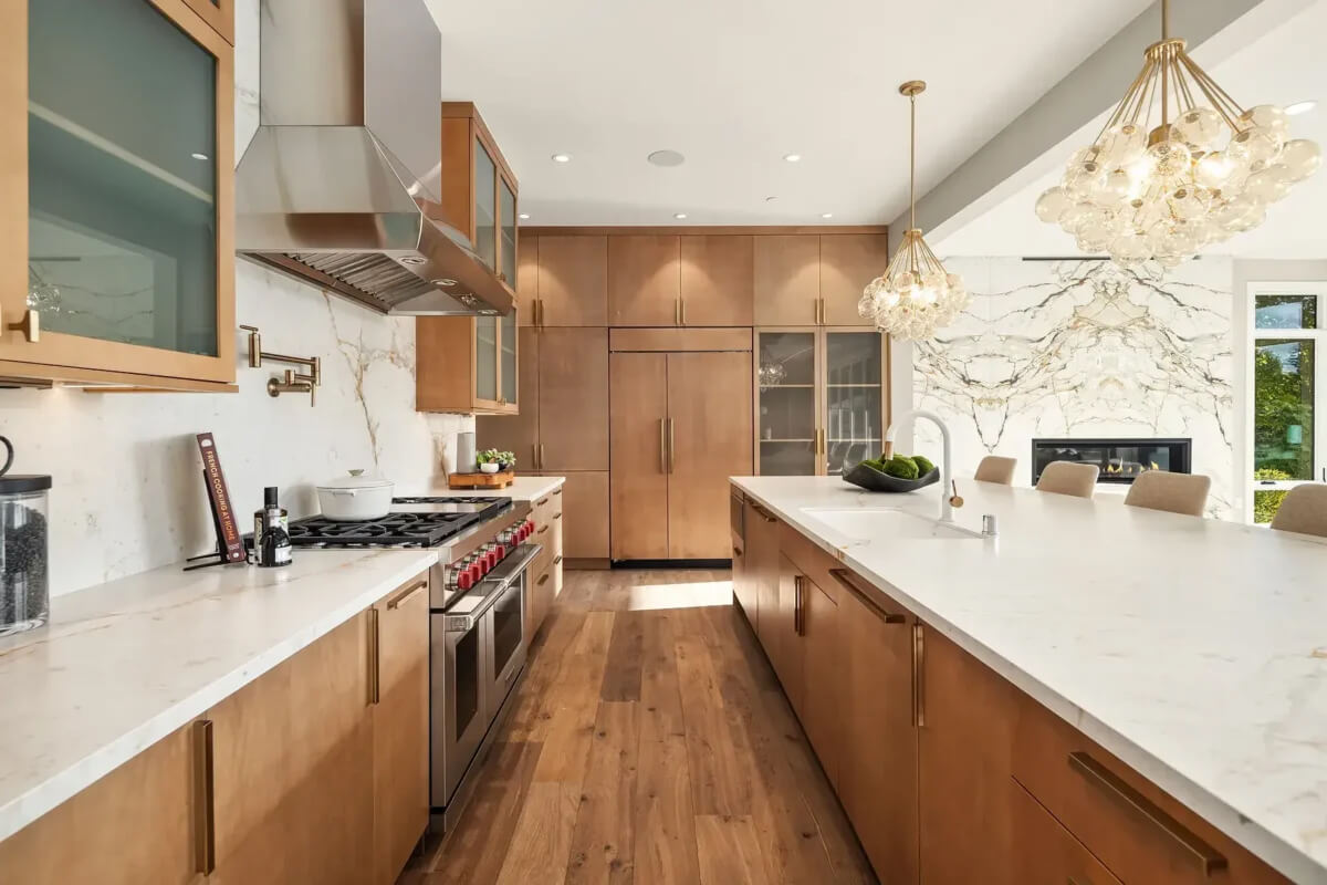 Modern kitchen renovation with white cabinets, granite countertops, and stainless steel appliances showing completed remodel