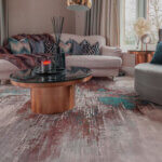 Modern geometric rug in living room with contemporary furniture and neutral color scheme