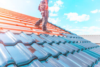 Professional roofers in Richmond installing new roof on residential home with modern tools and safety equipment