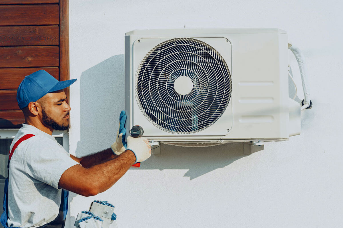 Licensed HVAC technician performing repair work on heating system in Portland Oregon home