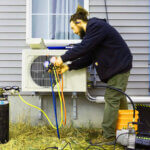 Professional heat pump installation with outdoor unit being installed by HVAC technician for home heating and cooling