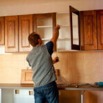 DIY cabinet refacing ideas showing before and after kitchen transformation with new doors and painted veneer