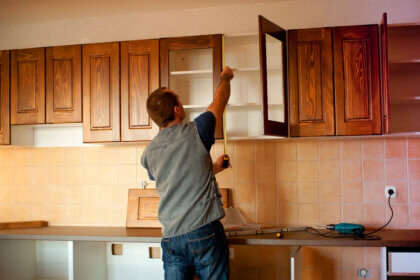 DIY cabinet refacing ideas showing before and after kitchen transformation with new doors and painted veneer