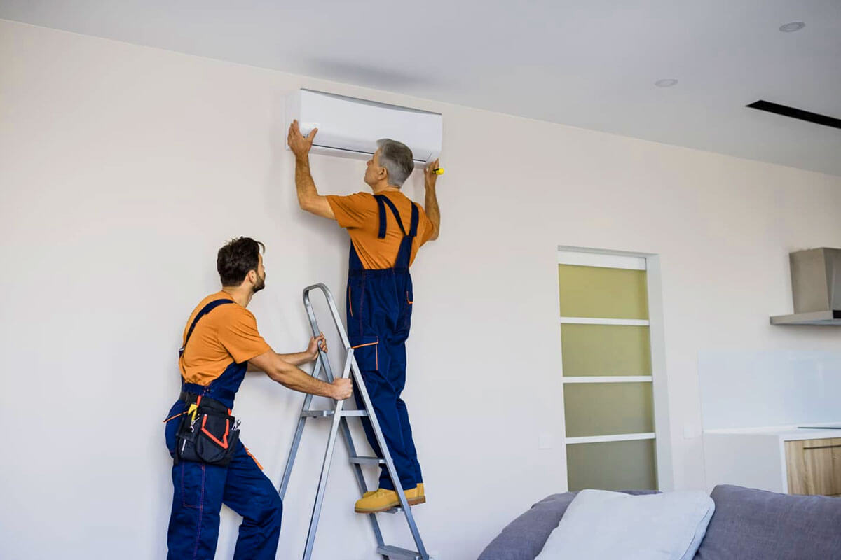 Professional technician installing new AC unit in Riverview Florida home during summer