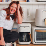 Best kitchen appliances for housewarming gifts including air fryer stand mixer and coffee maker on modern kitchen counter