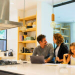 Kitchen remodeling specialists working on cabinet installation in modern home renovation project