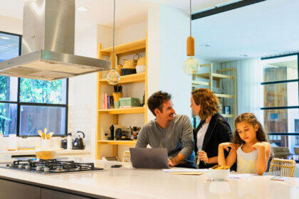 Kitchen remodeling specialists working on cabinet installation in modern home renovation project