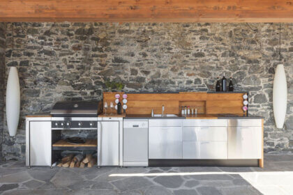 Affordable outdoor modular kitchen with stainless steel grill island and storage cabinets in modern backyard setting