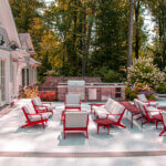 Modern outdoor pool furniture ideas featuring teak chaise lounges and weather-resistant seating around swimming pool