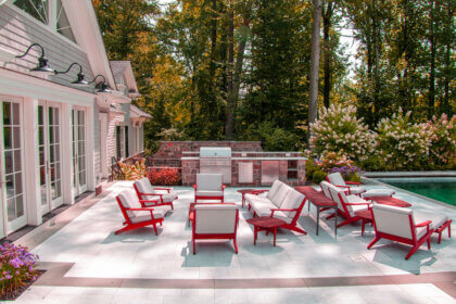 Modern outdoor pool furniture ideas featuring teak chaise lounges and weather-resistant seating around swimming pool