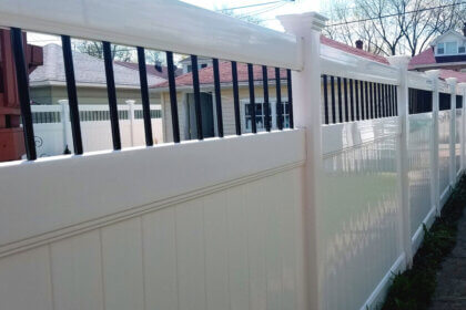 White plastic fencing panels installed in residential backyard showing durable PVC fence design and low maintenance benefits
