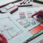 Step-by-step home renovation checklist with planning documents and tools on table
