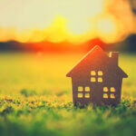 Homeowner checking AC filter during summer home maintenance tips routine to save cooling costs