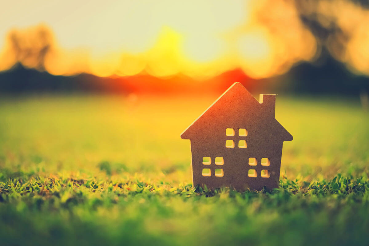 Homeowner checking AC filter during summer home maintenance tips routine to save cooling costs