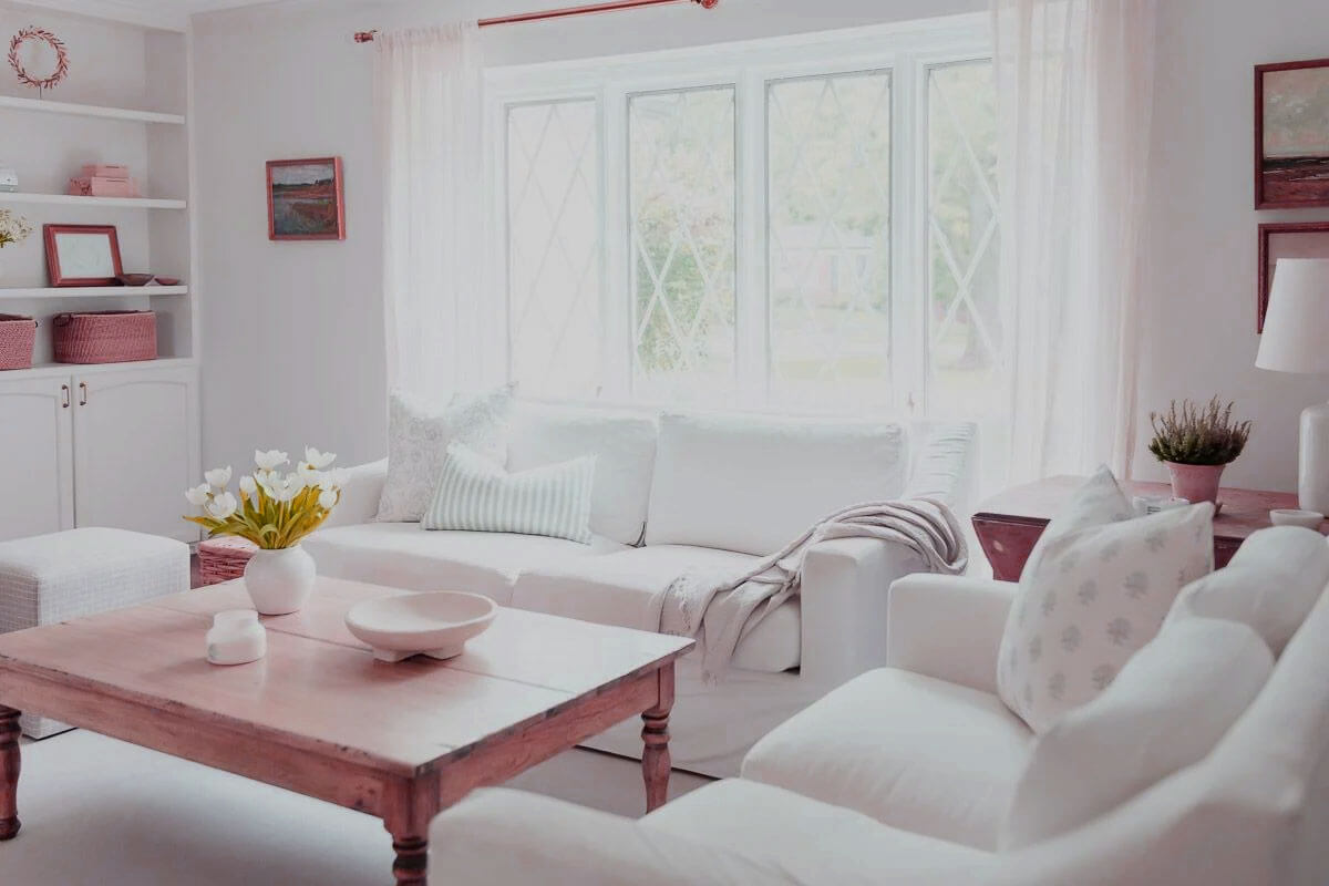 White home interior design living room with warm lighting, textured pillows, and natural wood accents