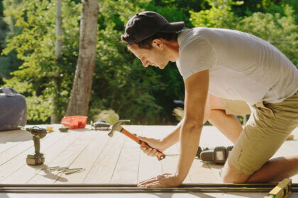 Homeowner using DrHomey handy tips checklist with basic tools for DIY home maintenance and repairs