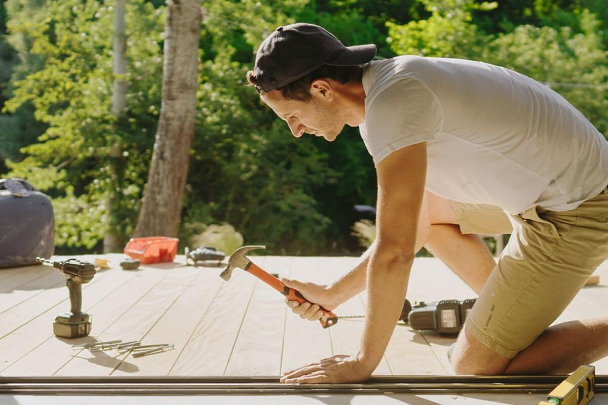 Homeowner using DrHomey handy tips checklist with basic tools for DIY home maintenance and repairs