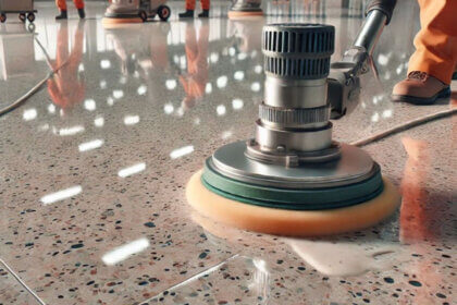 Person using microfiber mop to clean terrazzo floors with neutral pH cleaner and water bucket