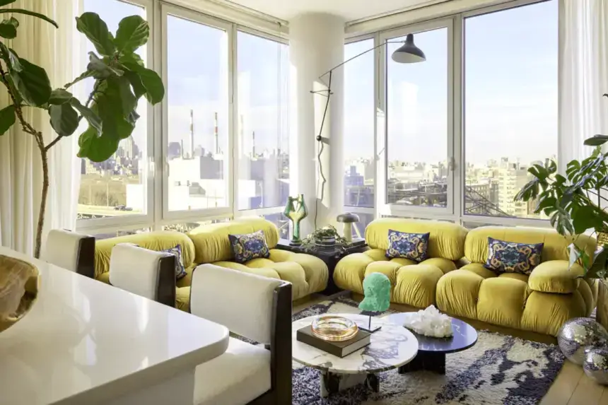 Interior design tips for small apartments showing bright living room with yellow sofa, large windows, plants, and space-saving furniture