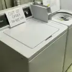 Criterion brand top-load washer with out of order sign showing common washer problems and malfunctions