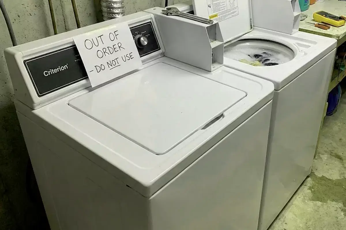 Criterion brand top-load washer with out of order sign showing common washer problems and malfunctions