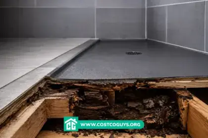 A contractor rolling liquid waterproofing membrane onto a shower pan before tile installation