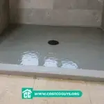 Pre Sloped Shower Base filled with water during a flood test in a tiled walk-in shower before final floor installation