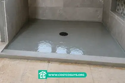 Pre Sloped Shower Base filled with water during a flood test in a tiled walk-in shower before final floor installation