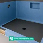 Shower membrane and shower pan installation with blue waterproofing walls and black base in unfinished bathroom