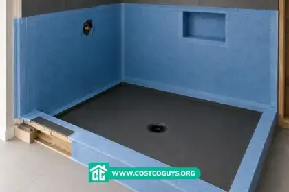 Shower membrane and shower pan installation with blue waterproofing walls and black base in unfinished bathroom