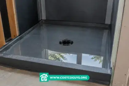 Shower pan underlayment with water-filled liner during flood test in unfinished bathroom stall