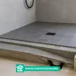 walk in shower floor slope under construction with tiled surface, mortar bed layers, and exposed drain plumbing