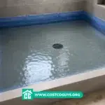 Waterproofing shower base flood test with filled tiled shower pan and blue waterproof membrane along walls
