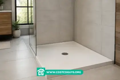 White shower pan in a modern tiled bathroom with a glass shower enclosure