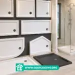 Multiple shower bases in different sizes and shapes displayed in a bathroom showroom