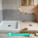 tile shower pan kit installation with waterproof membrane and drain on subfloor